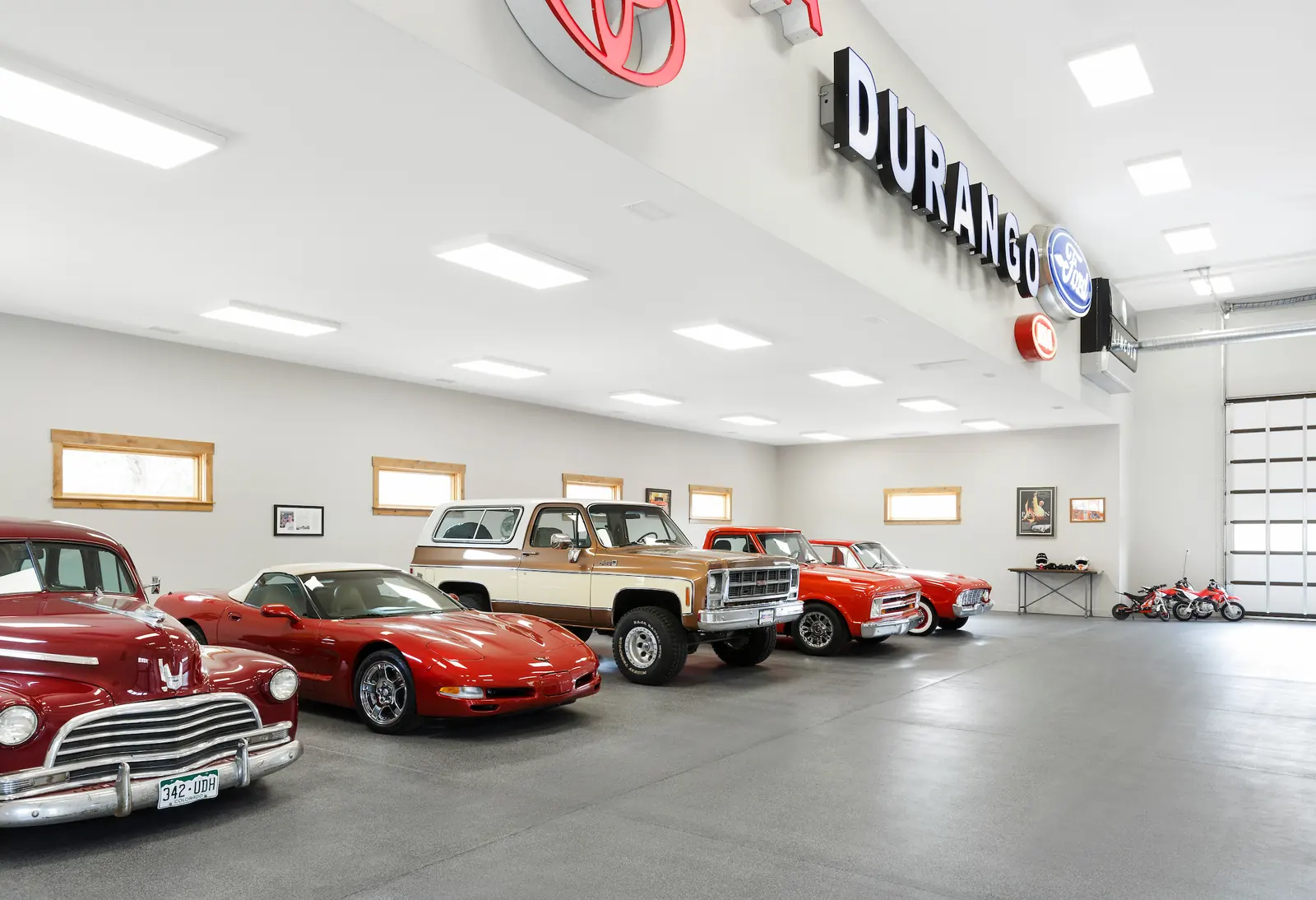 Collector cars parked inside the finished garage, Glorified Garage, Refined Designs by Natalie