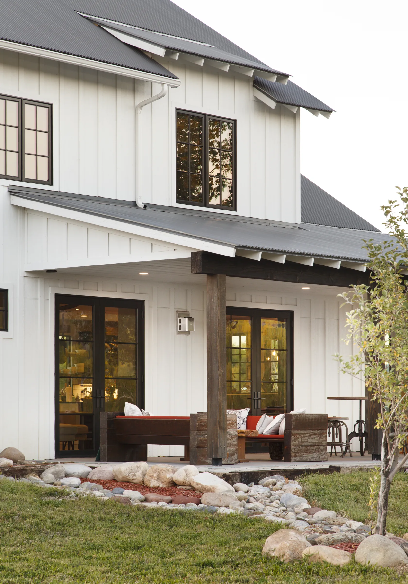 Two-story board and batten exterior with covered porch, Bright and Airy Farmhouse, Refined Designs by Natalie