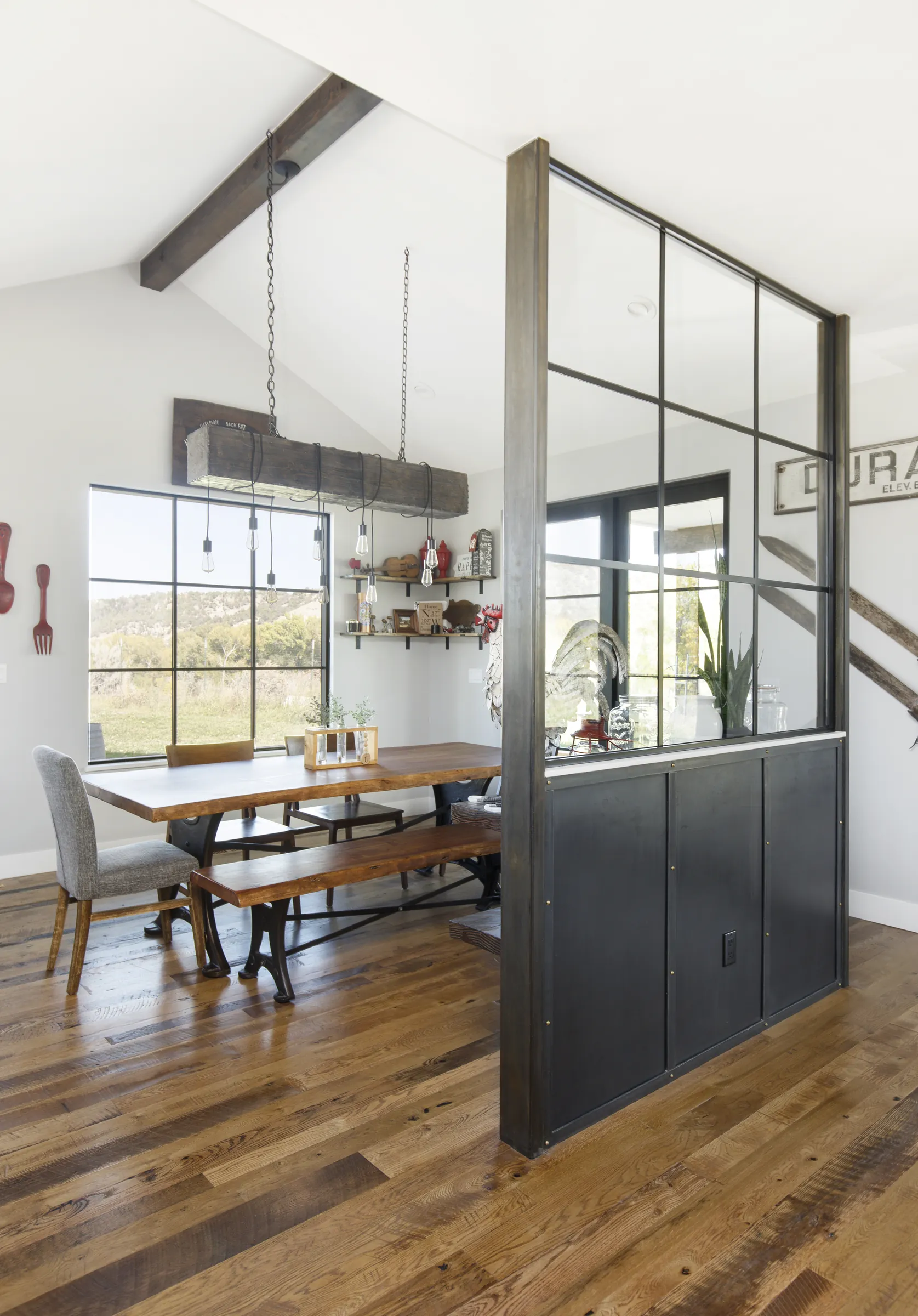 Dining room with beam light fixture and steel partition, Bright and Airy Farmhouse, Refined Designs by Natalie
