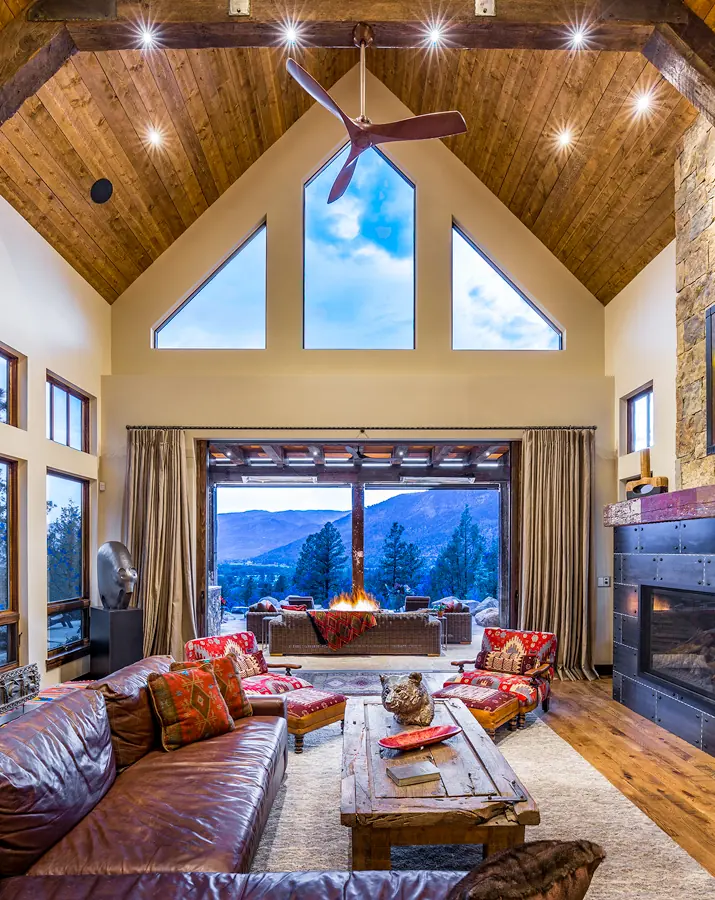 Vaulted living room with a window wall to the mountains, Rustic Mountain Retreat, Refined Designs by Natalie