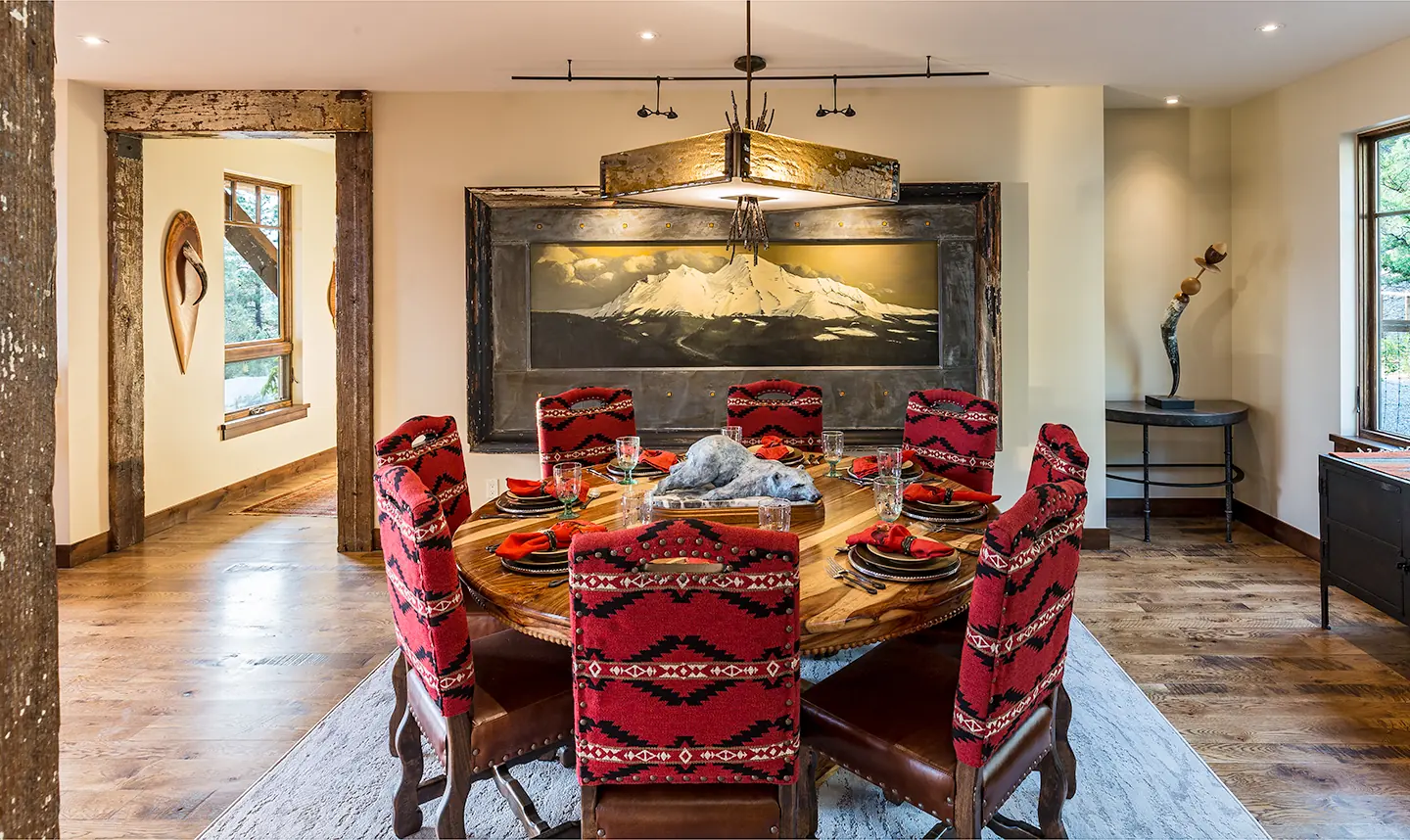 Dining room with a round table and mountain artwork, Rustic Mountain Retreat, Refined Designs by Natalie