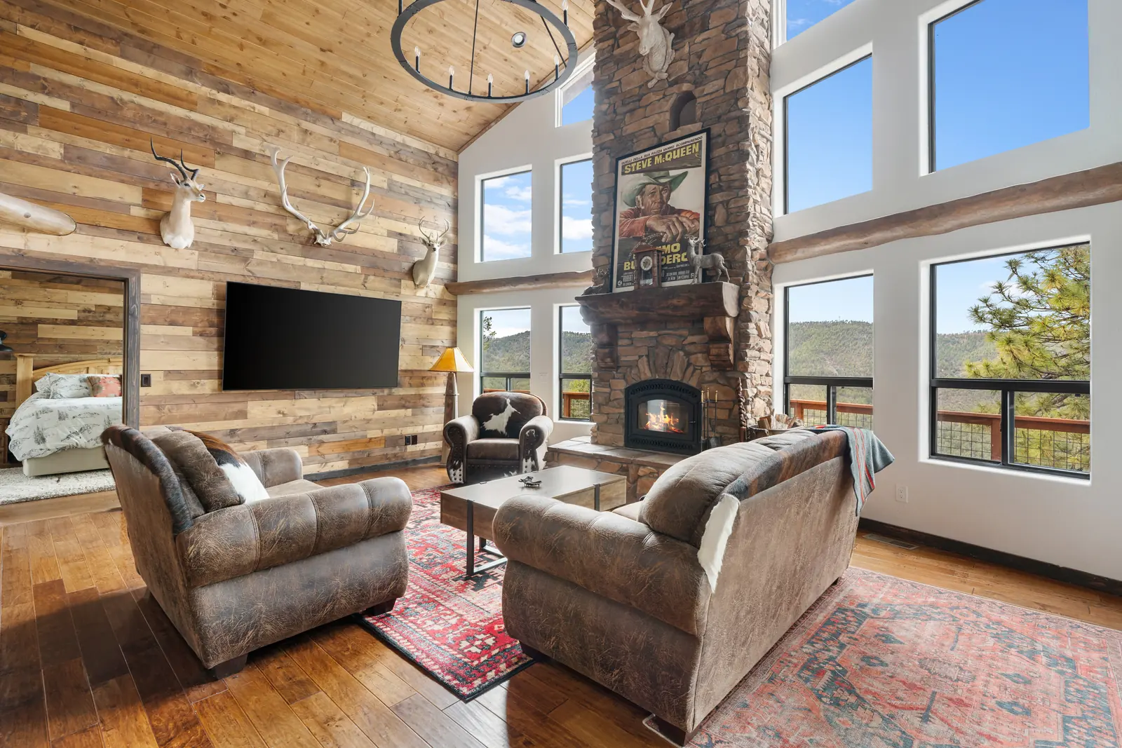 Living room with exposed timber posts and hardwood floors, Daybreak at Ponderosa, Refined Designs by Natalie