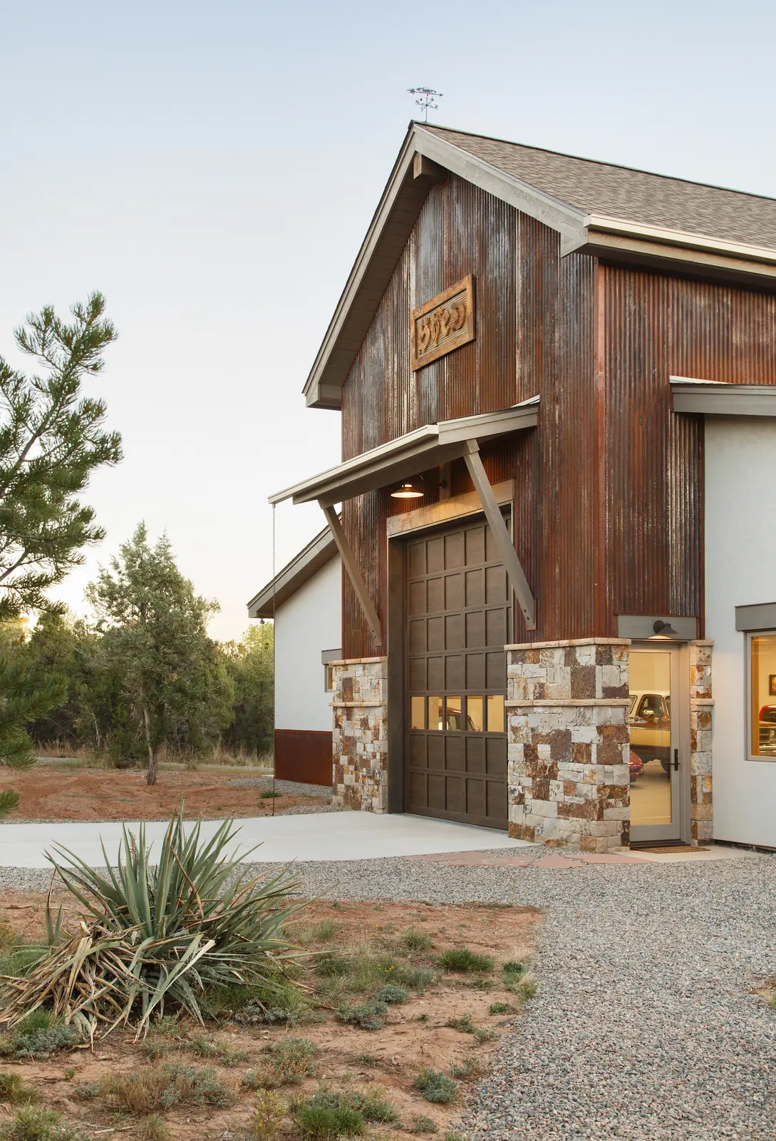 Exterior showing corrugated metal, stone and log columns, Glorified Garage, Refined Designs by Natalie