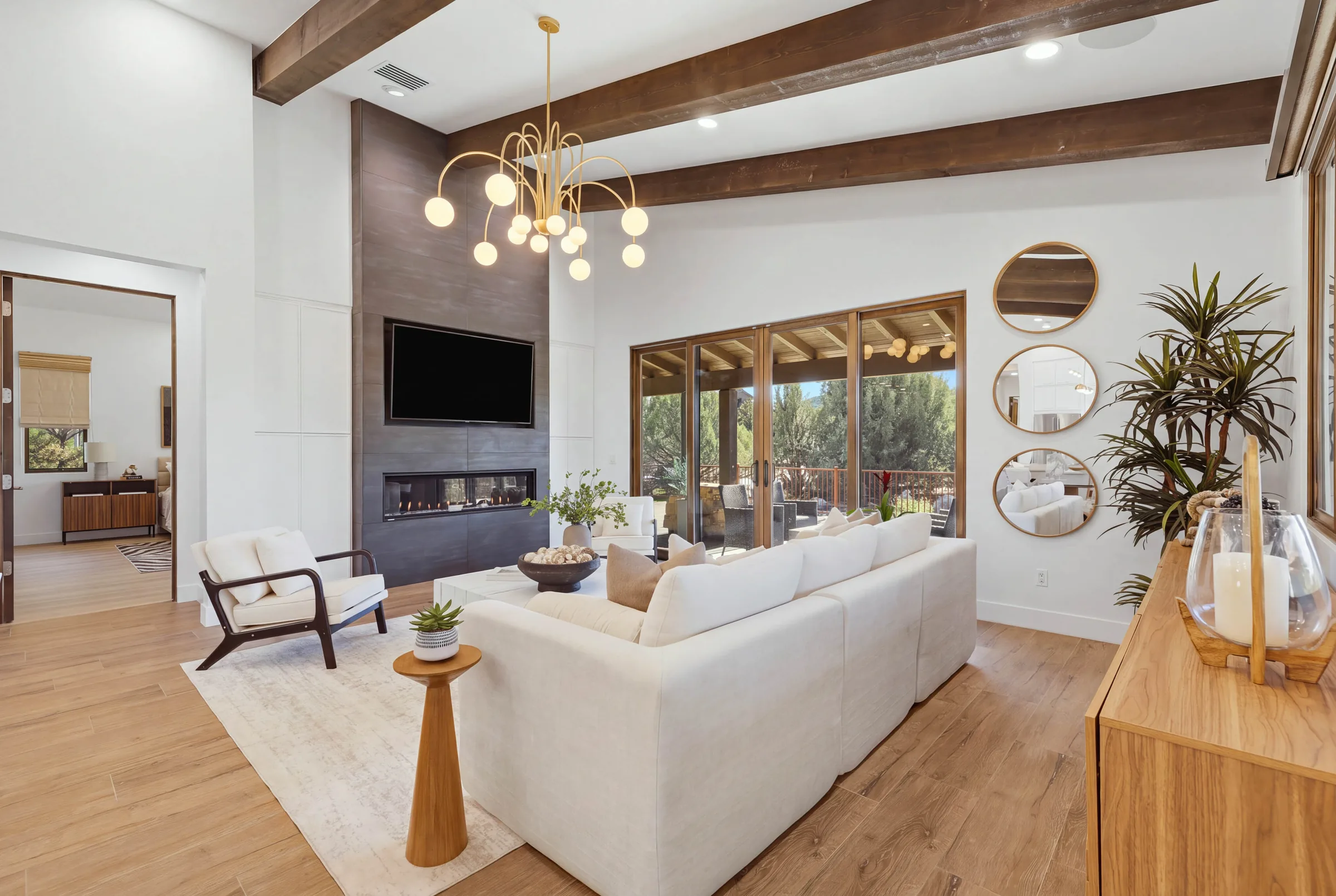 Living room with floor to ceiling tile fireplace under exposed beams, The Modern Ranch Revival, Refined Designs by Natalie, Prescott, Arizona